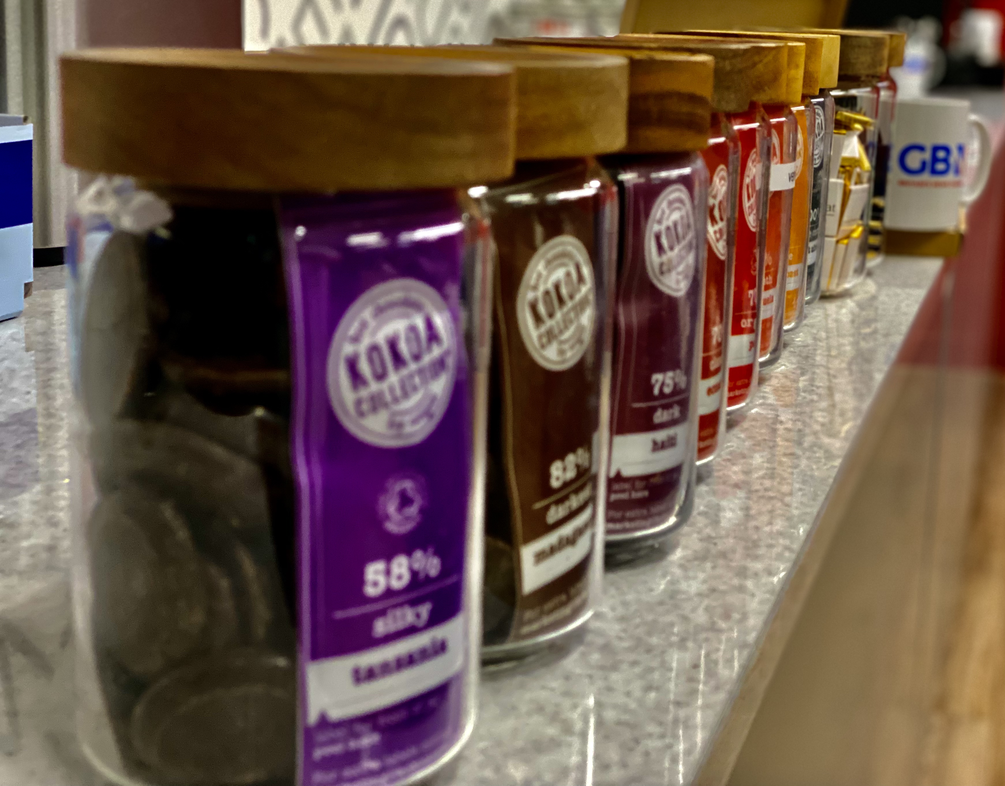 jars of different percentage chocolate on a shelf